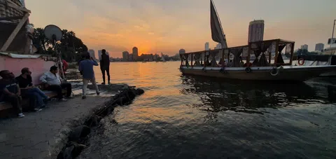 The Nile felucca at dusk — Cairo's lateen-rigged sailboats and the captains who've worked the river for generations